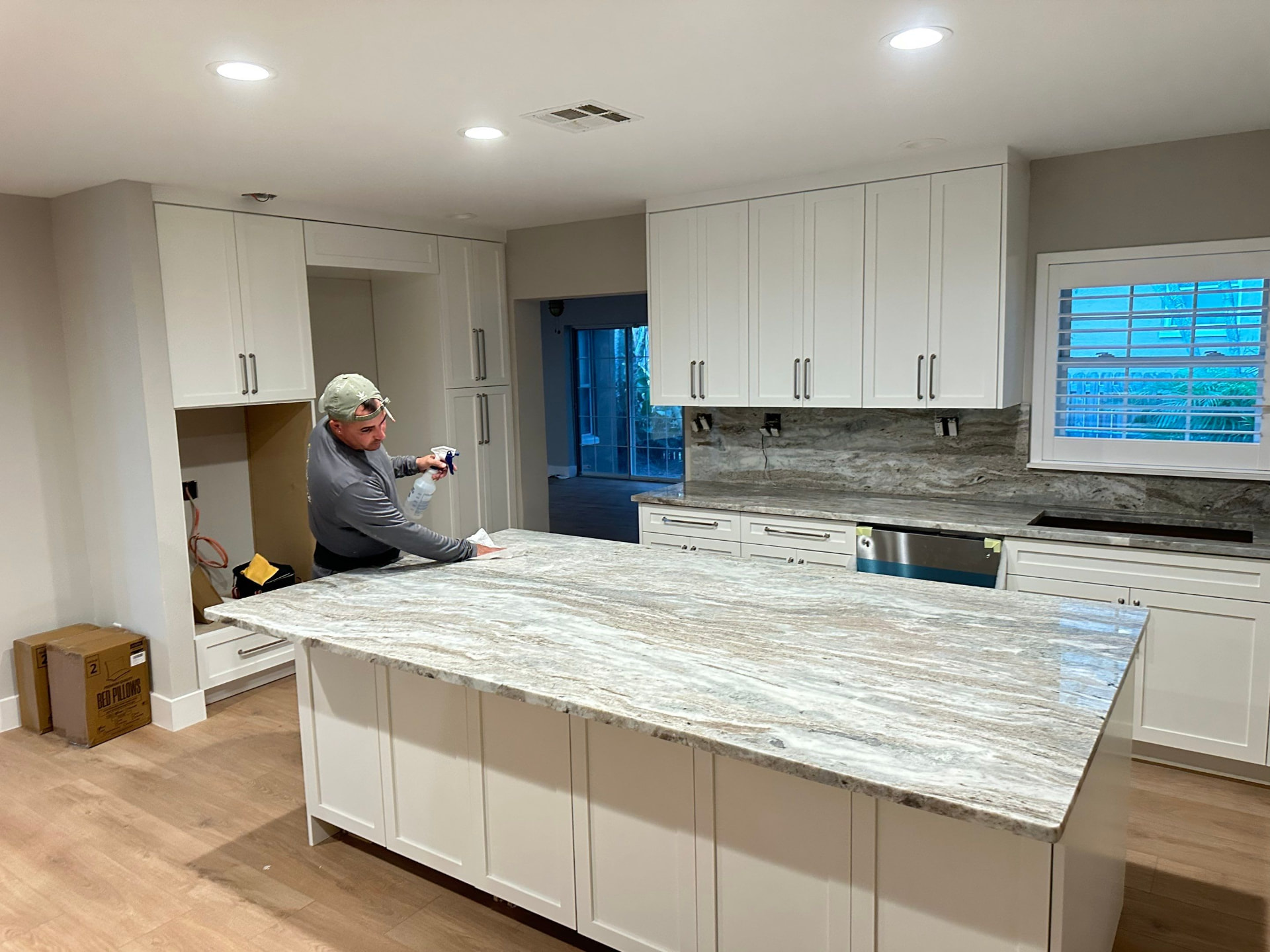Installer finishing a white kitchen in Tampa